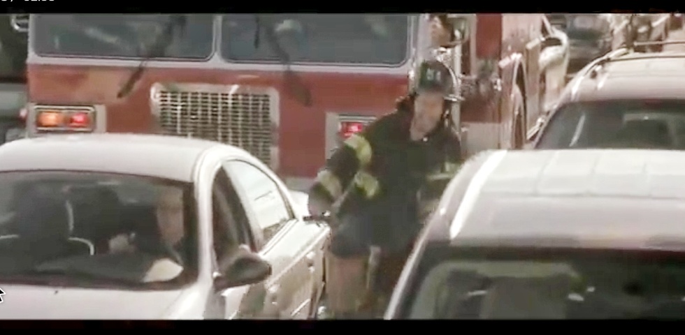 Tommy_Wahlberg_Firefighter_Bicycling_past_fire-truck